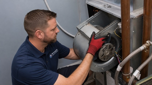 Technician with AC condenser unit
