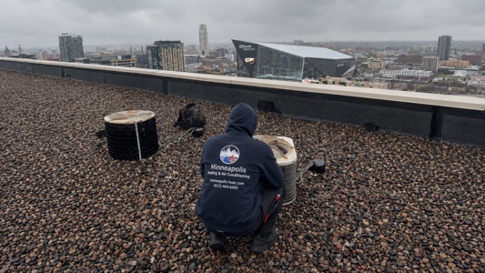 HVAC technician servicing outdoor AC unit